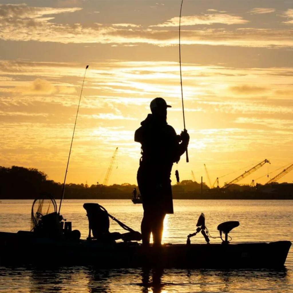Man Fishing on Kayak During Sunset