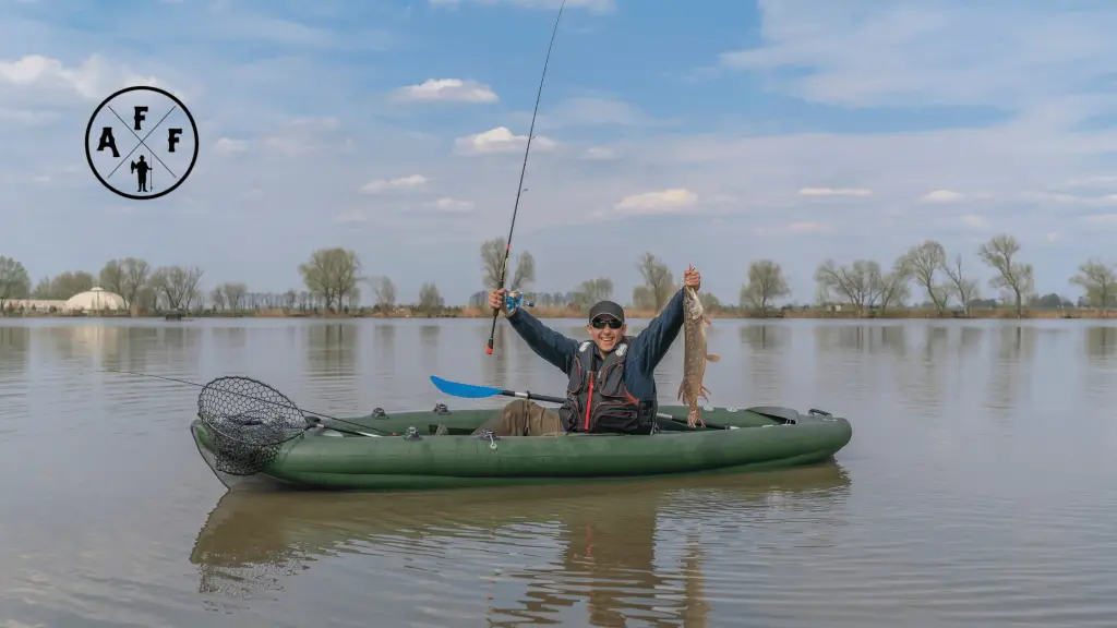 Man with fish on inflatable fishing kayak