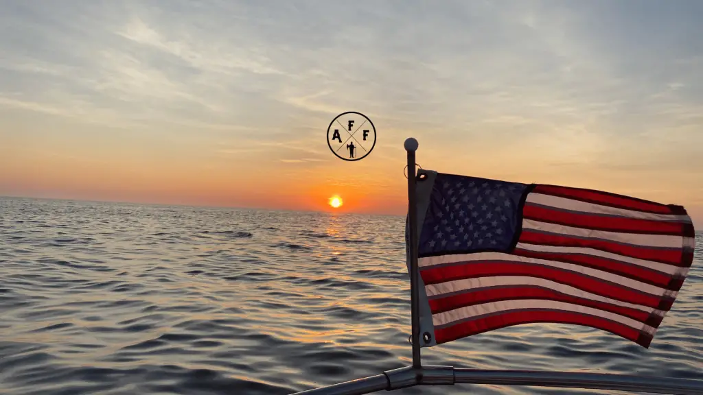 American flag on boat during sunset